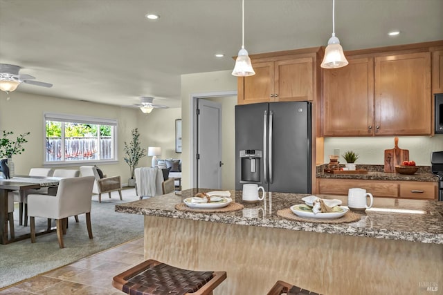 687 Cabot Way, Napa, CA 94559 - kitchen with stainless steel fridge with ice dispenser, ceiling fan, dark stone counters, hanging light fixtures, and recessed lighting