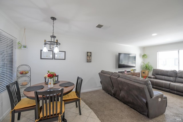 433 Freeway Dr, Napa, CA 94558 - dining area with crown molding, light tile patterned floors, a chandelier, baseboards, and light carpet