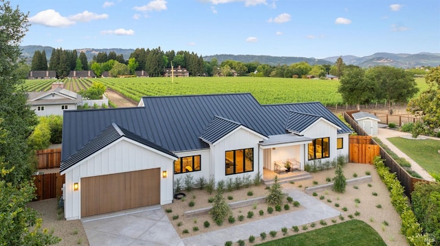 1597 Arrowhead Dr, Saint Helena, CA 94574 - view of front of property featuring a standing seam roof, metal roof, board and batten siding, concrete driveway, and agricultural plots