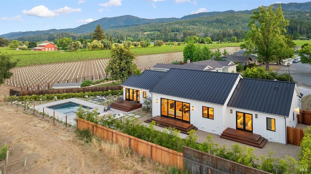 1597 Arrowhead Dr, Saint Helena, CA 94574 - back of property with a fenced backyard, metal roof, a deck with mountain view, a standing seam roof, and board and batten siding