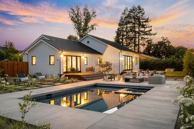 1597 Arrowhead Dr, Saint Helena, CA 94574 - back of house at dusk with french doors, a standing seam roof, an outdoor living space, metal roof, and a patio