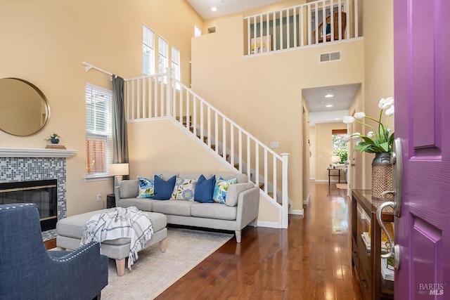 4 San Pablo Ct, Novato, CA 94949 - living area featuring a high ceiling, hardwood / wood-style floors, stairway, a tile fireplace, and baseboards