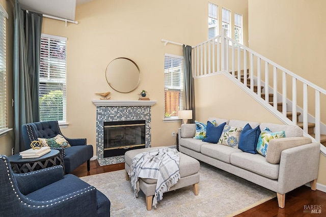 4 San Pablo Ct, Novato, CA 94949 - living room with wood finished floors, a glass covered fireplace, a towering ceiling, and stairs