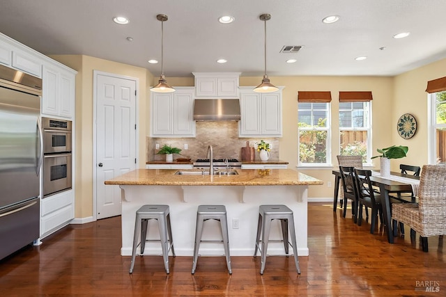 4 San Pablo Ct, Novato, CA 94949 - kitchen featuring appliances with stainless steel finishes, a sink, decorative backsplash, white cabinets, and dark wood-style flooring