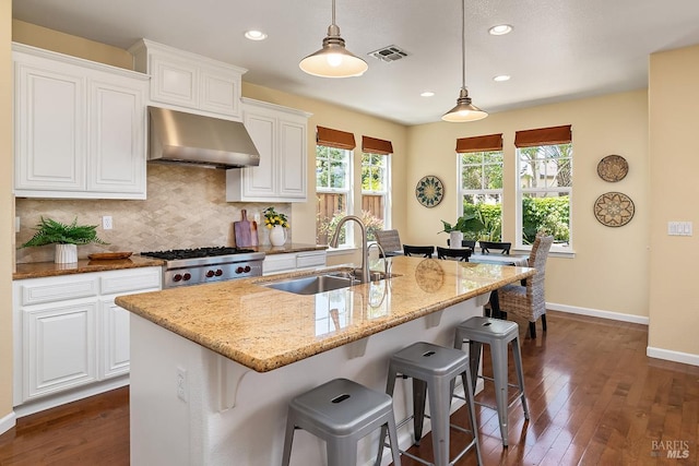 4 San Pablo Ct, Novato, CA 94949 - kitchen featuring wall chimney exhaust hood, a sink, light stone counters, dark wood-style floors, and baseboards