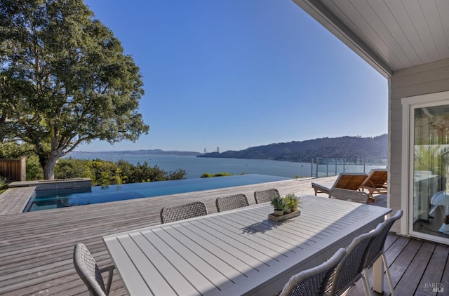 22 Eucalyptus Rd, Belvedere, CA 94920 - deck featuring a water and mountain view, outdoor dining space, and an outdoor pool