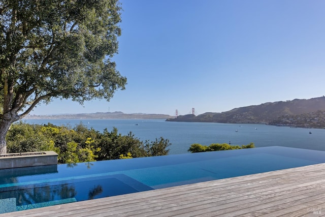 22 Eucalyptus Rd, Belvedere, CA 94920 - view of swimming pool with a pool with connected hot tub and a deck with water view