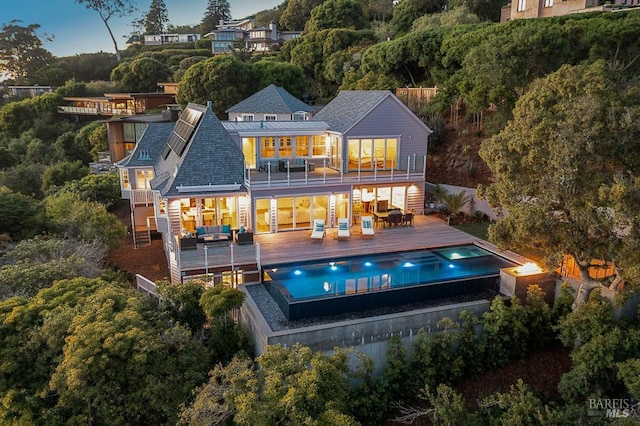 22 Eucalyptus Rd, Belvedere, CA 94920 - rear view of house featuring a balcony, an outdoor hot tub, an outdoor living space, an outdoor pool, and a shingled roof