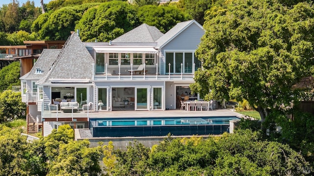 22 Eucalyptus Rd, Belvedere, CA 94920 - back of property featuring a balcony, an outdoor pool, an outdoor hangout area, and outdoor dining space