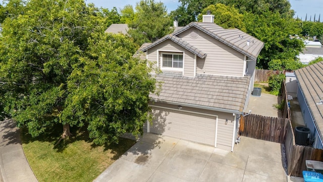 1191 Araquipa Ct, Vacaville, CA 95687 - view of front of house featuring a garage, concrete driveway, central AC, a chimney, and a tile roof