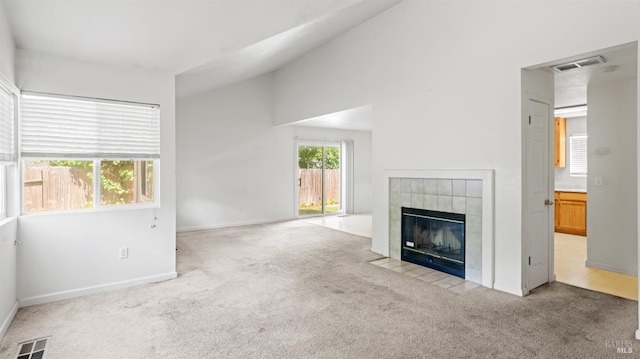 1191 Araquipa Ct, Vacaville, CA 95687 - unfurnished living room featuring carpet flooring, a tile fireplace, baseboards, and lofted ceiling