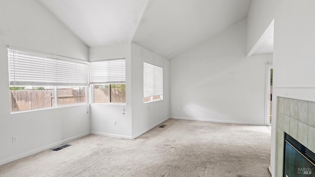 1191 Araquipa Ct, Vacaville, CA 95687 - carpeted empty room featuring lofted ceiling, healthy amount of natural light, a tiled fireplace, and baseboards