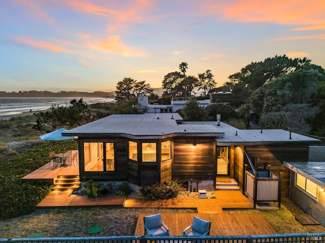 8 Rafael Patio, Stinson Beach, CA 94970 - back of property at dusk with a wooden deck and outdoor dining space
