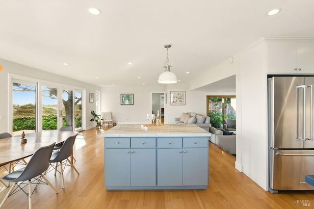 8 Rafael Patio, Stinson Beach, CA 94970 - kitchen with high end fridge, open floor plan, light wood-style flooring, blue cabinets, and recessed lighting