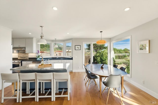 8 Rafael Patio, Stinson Beach, CA 94970 - kitchen featuring under cabinet range hood, gas range, dark countertops, recessed lighting, and a sink
