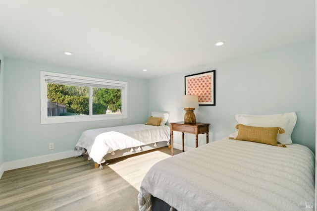 8 Rafael Patio, Stinson Beach, CA 94970 - bedroom featuring baseboards, wood finished floors, and recessed lighting