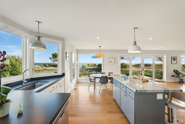 8 Rafael Patio, Stinson Beach, CA 94970 - kitchen featuring a sink, light wood-style floors, a breakfast bar area, healthy amount of natural light, and recessed lighting