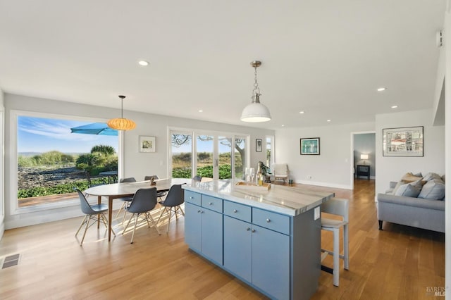 8 Rafael Patio, Stinson Beach, CA 94970 - kitchen featuring a center island, recessed lighting, light wood-style flooring, open floor plan, and a kitchen bar