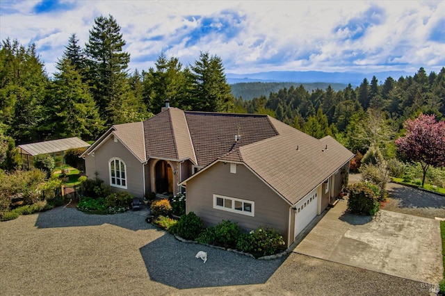 7785 Torgersen Rd, Eureka, CA 95503 - view of front facade with a garage, a forest view, and concrete driveway