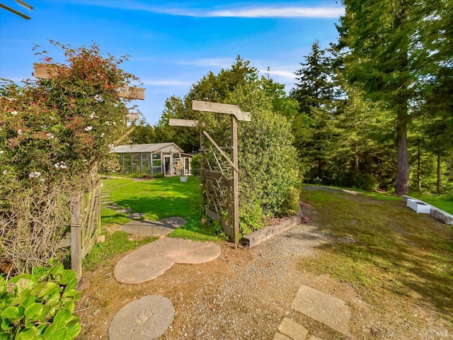 7785 Torgersen Rd, Eureka, CA 95503 - view of grassy yard with a sunroom and a garden