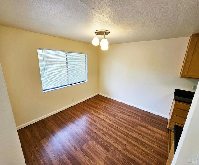 900 Cambridge Dr Unit 122, Benicia, CA 94510 - unfurnished dining area featuring dark wood-style flooring, a textured ceiling, and baseboards