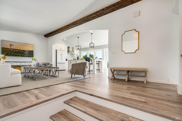 12 Maidu Ct, Napa, CA 94558 - living room with light wood-style flooring, arched walkways, baseboards, and a chandelier