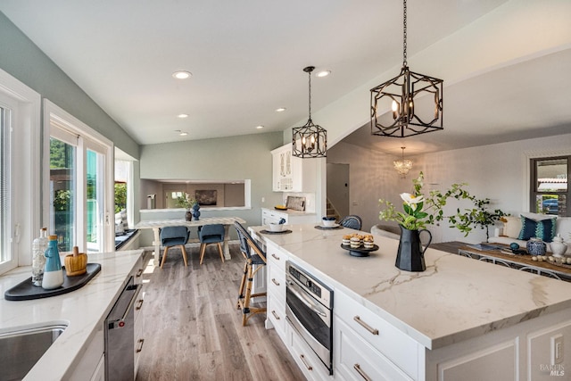 12 Maidu Ct, Napa, CA 94558 - kitchen with a chandelier, appliances with stainless steel finishes, light wood-style floors, white cabinetry, and light stone countertops