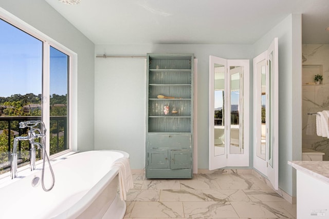 12 Maidu Ct, Napa, CA 94558 - full bath featuring marble look tile flooring, a freestanding bath, and baseboards