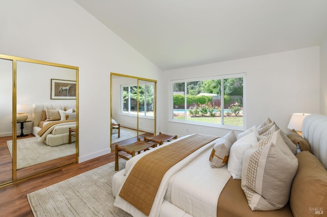 914 Cottonwood Ct, Petaluma, CA 94954 - bedroom featuring two closets, multiple windows, wood finished floors, baseboards, and high vaulted ceiling