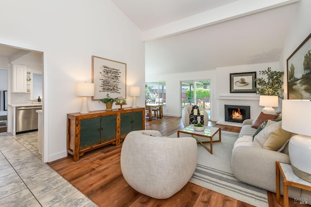 914 Cottonwood Ct, Petaluma, CA 94954 - living room with high vaulted ceiling, a brick fireplace, beamed ceiling, baseboards, and light wood-style floors
