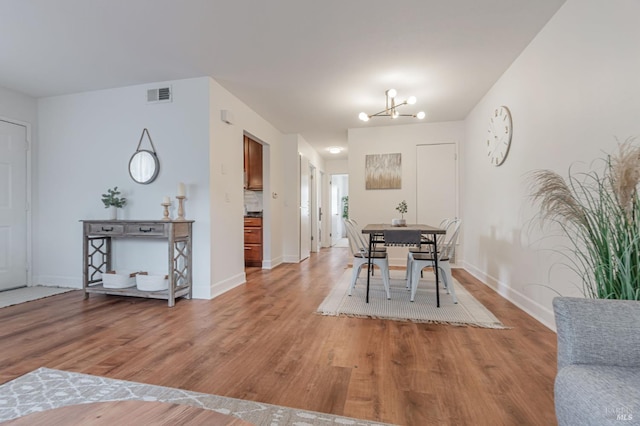 64 Los Padres Cir, Novato, CA 94947 - dining room featuring light wood-type flooring, a chandelier, and baseboards