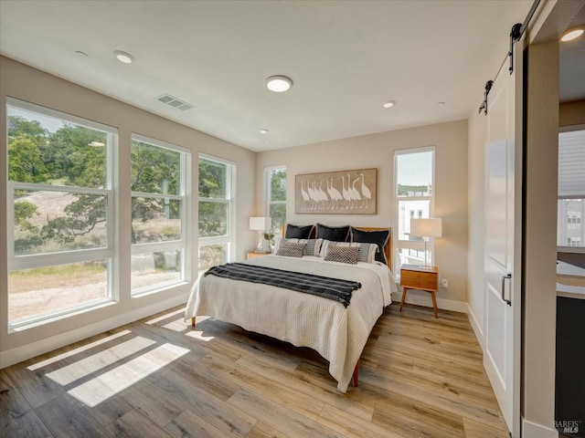 226 Verandah Ave, Novato, CA 94945 - bedroom with a barn door, light wood-type flooring, baseboards, and recessed lighting