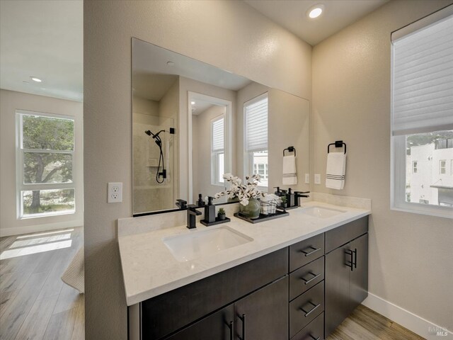 226 Verandah Ave, Novato, CA 94945 - bathroom featuring wood finished floors, baseboards, a tile shower, double vanity, and recessed lighting