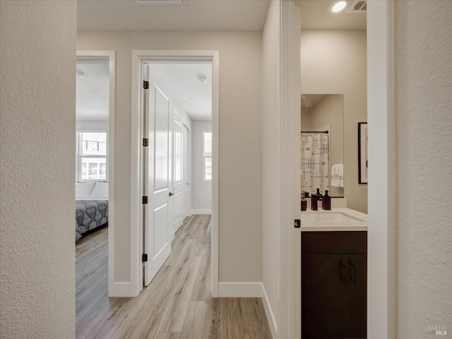 226 Verandah Ave, Novato, CA 94945 - hallway featuring light wood finished floors, baseboards, a sink, and a textured wall