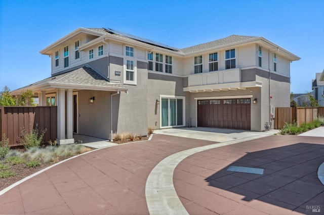 1749 Guadalupe St, Petaluma, CA 94952 - view of front of house with concrete driveway, stucco siding, solar panels, an attached garage, and roof with shingles