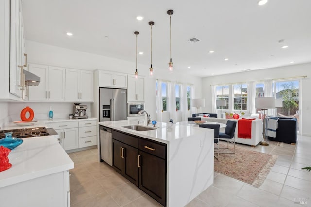 1749 Guadalupe St, Petaluma, CA 94952 - kitchen with stainless steel appliances, a sink, open floor plan, light tile patterned flooring, and white cabinetry