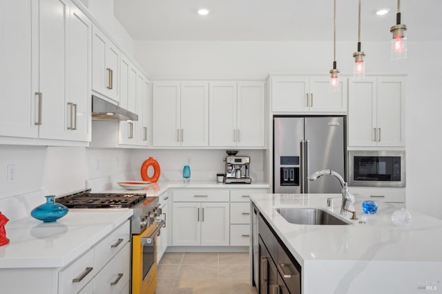 1749 Guadalupe St, Petaluma, CA 94952 - kitchen with high quality appliances, a sink, under cabinet range hood, white cabinets, and a kitchen island with sink