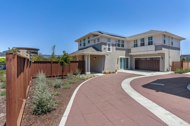 1749 Guadalupe St, Petaluma, CA 94952 - view of front of house with concrete driveway, stucco siding, solar panels, and a garage