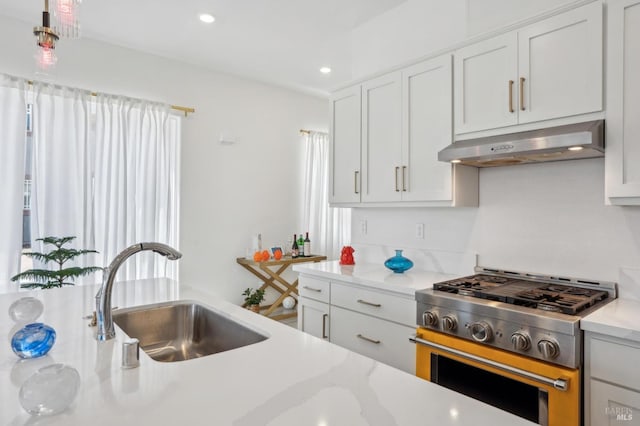 1749 Guadalupe St, Petaluma, CA 94952 - kitchen featuring high end range, under cabinet range hood, a sink, recessed lighting, and white cabinets