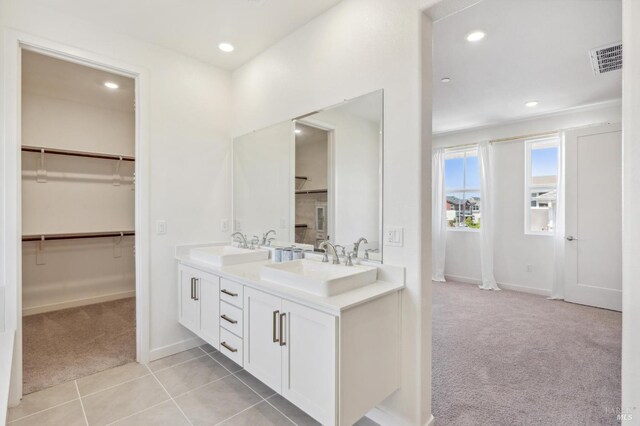 1749 Guadalupe St, Petaluma, CA 94952 - bathroom featuring double vanity, baseboards, recessed lighting, tile patterned floors, and a walk in closet