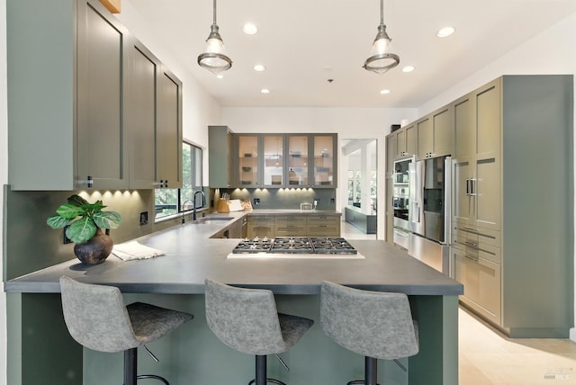 119 Marguerite Ave, Mill Valley, CA 94941 - kitchen with appliances with stainless steel finishes, a sink, a peninsula, hanging light fixtures, and recessed lighting
