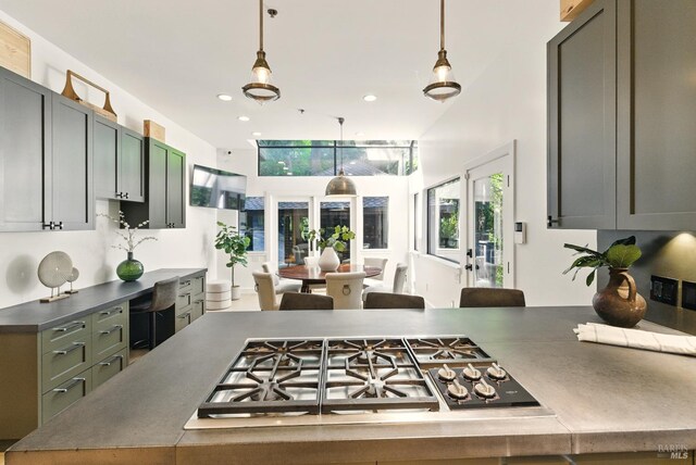 119 Marguerite Ave, Mill Valley, CA 94941 - kitchen featuring stainless steel gas cooktop, white dishwasher, a sink, hanging light fixtures, and a peninsula
