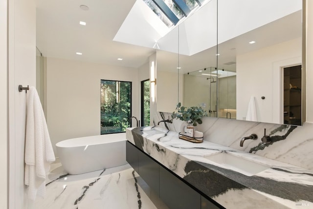 119 Marguerite Ave, Mill Valley, CA 94941 - full bathroom with marble tiled floors, double vanity, a freestanding bath, a stall shower, and a skylight