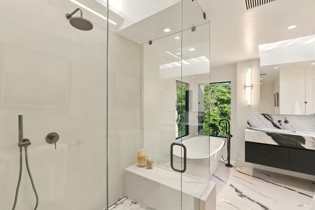 119 Marguerite Ave, Mill Valley, CA 94941 - full bath featuring marble tiled floors, double vanity, a freestanding bath, a shower stall, and a skylight