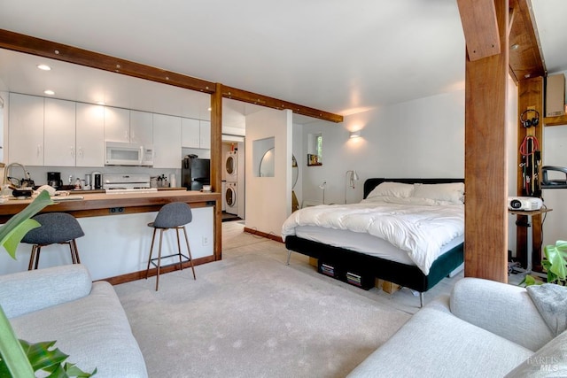 11 Inverness Way S, Inverness, CA 94937 - bedroom featuring stacked washing machine and dryer, beam ceiling, light carpet, freestanding refrigerator, and recessed lighting