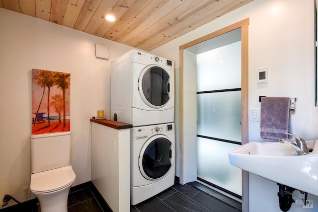11 Inverness Way S, Inverness, CA 94937 - washroom featuring estacked washer and dryer, wood ceiling, dark tile patterned floors, and recessed lighting