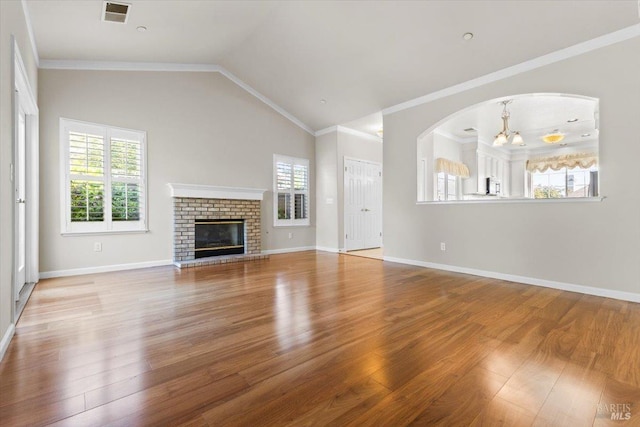 843 Cab Calloway Ct, Windsor, CA 95492 - unfurnished living room with a chandelier, plenty of natural light, wood finished floors, ornamental molding, and lofted ceiling