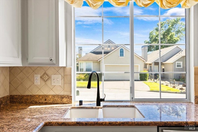 843 Cab Calloway Ct, Windsor, CA 95492 - detailed view of stone countertops, decorative backsplash, a sink, and white cabinets