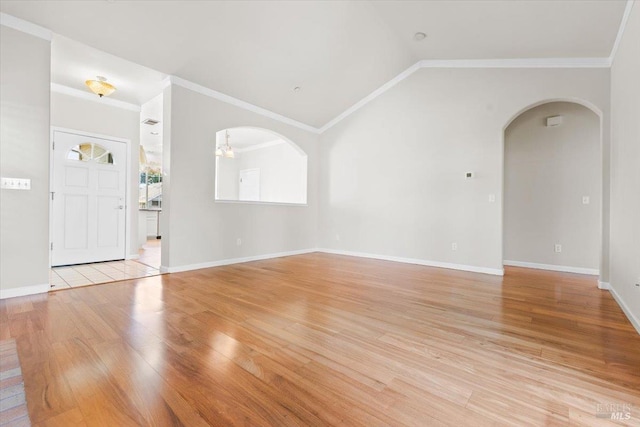 843 Cab Calloway Ct, Windsor, CA 95492 - unfurnished living room with arched walkways, light wood-style flooring, crown molding, vaulted ceiling, and baseboards
