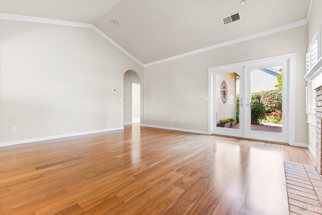 843 Cab Calloway Ct, Windsor, CA 95492 - unfurnished living room featuring arched walkways, light wood finished floors, vaulted ceiling, baseboards, and ornamental molding